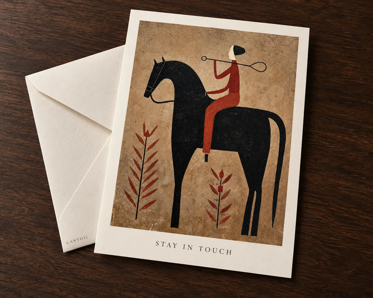 Desert Lasso cowboy artwork on a Canvoil art postcard with an ivory envelope on a dark wood table.