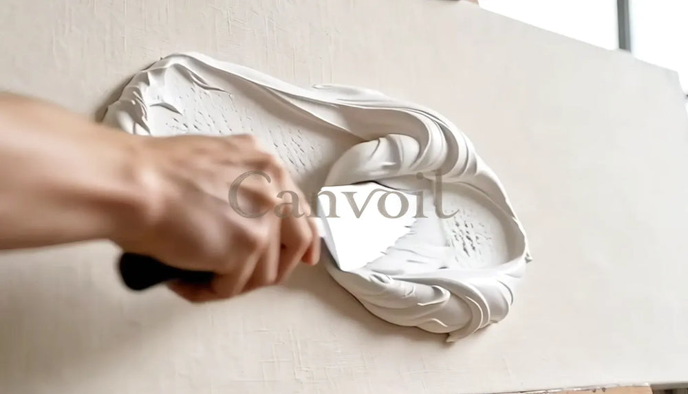 A palette knife shaping soft white texture on canvas.