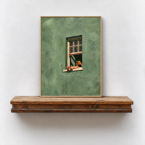 Framed reading-themed artwork resting on a rustic wood shelf against a white wall.