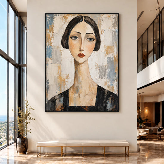 Large black-framed portrait of a woman above a bench in a tall, bright entryway.