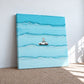Unframed blue car and surfer canvas leaning against a sunlit wall on a woven rug.