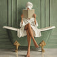 Full artwork of a woman in a white robe reading in a green clawfoot bathtub with gold feet against sage-green paneling.
