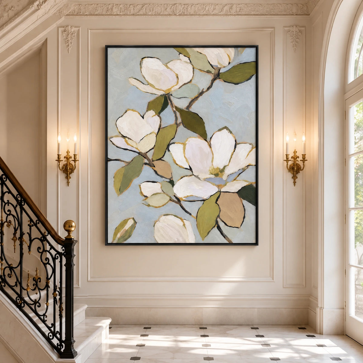 Magnolia painting in a black frame on a paneled staircase wall between candle sconces.