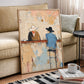 Western cowboy painting in a light wood frame leaning beside a neutral sofa and a coffee table.
