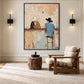 Cowboy bar painting in a black frame between wall sconces above a wood lounge chair.