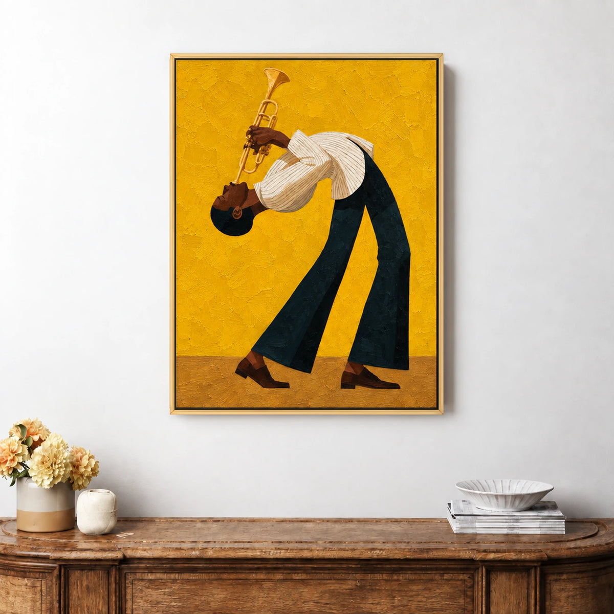 Framed golden jazz painting above a rustic sideboard with flowers and stacked dishes.