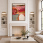 Rose and terracotta abstract painting above a fireplace between recessed shelves.