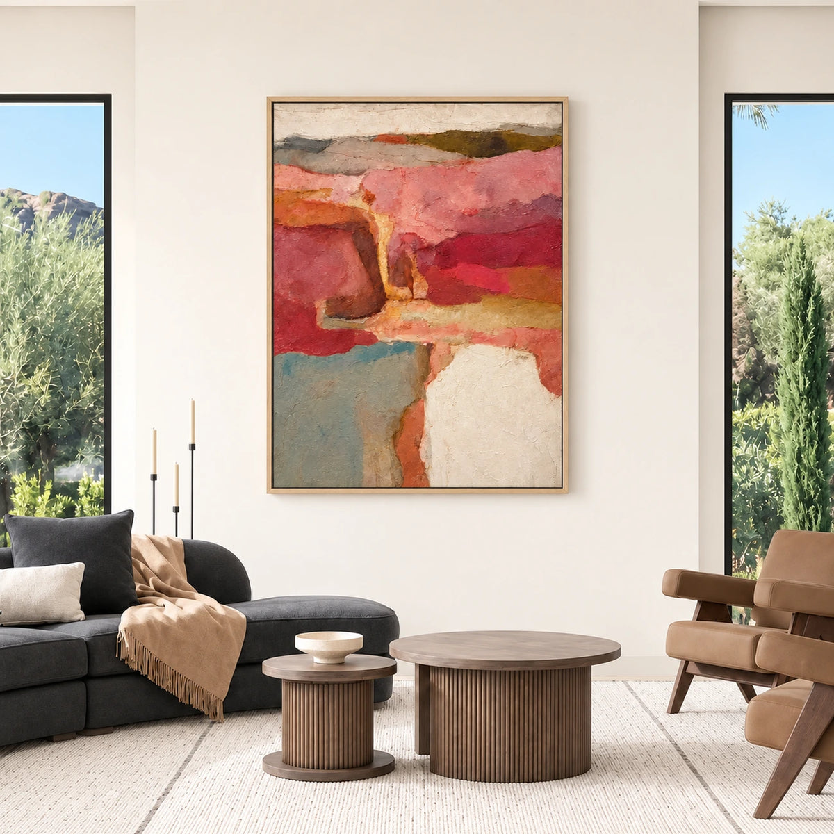 Rose Canyon painting between tall windows in a modern living room with dark seating and round coffee tables.