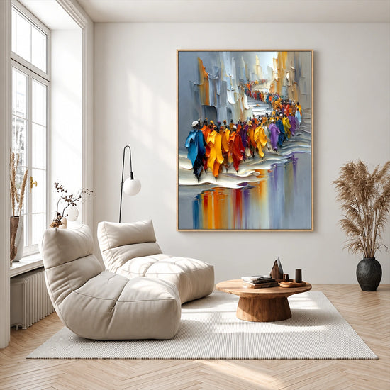 City Parade painting above a white lounge chair in a bright room with tall windows.