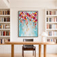 Bloom Cascade painting above a wood desk between white bookcases in a bright study.