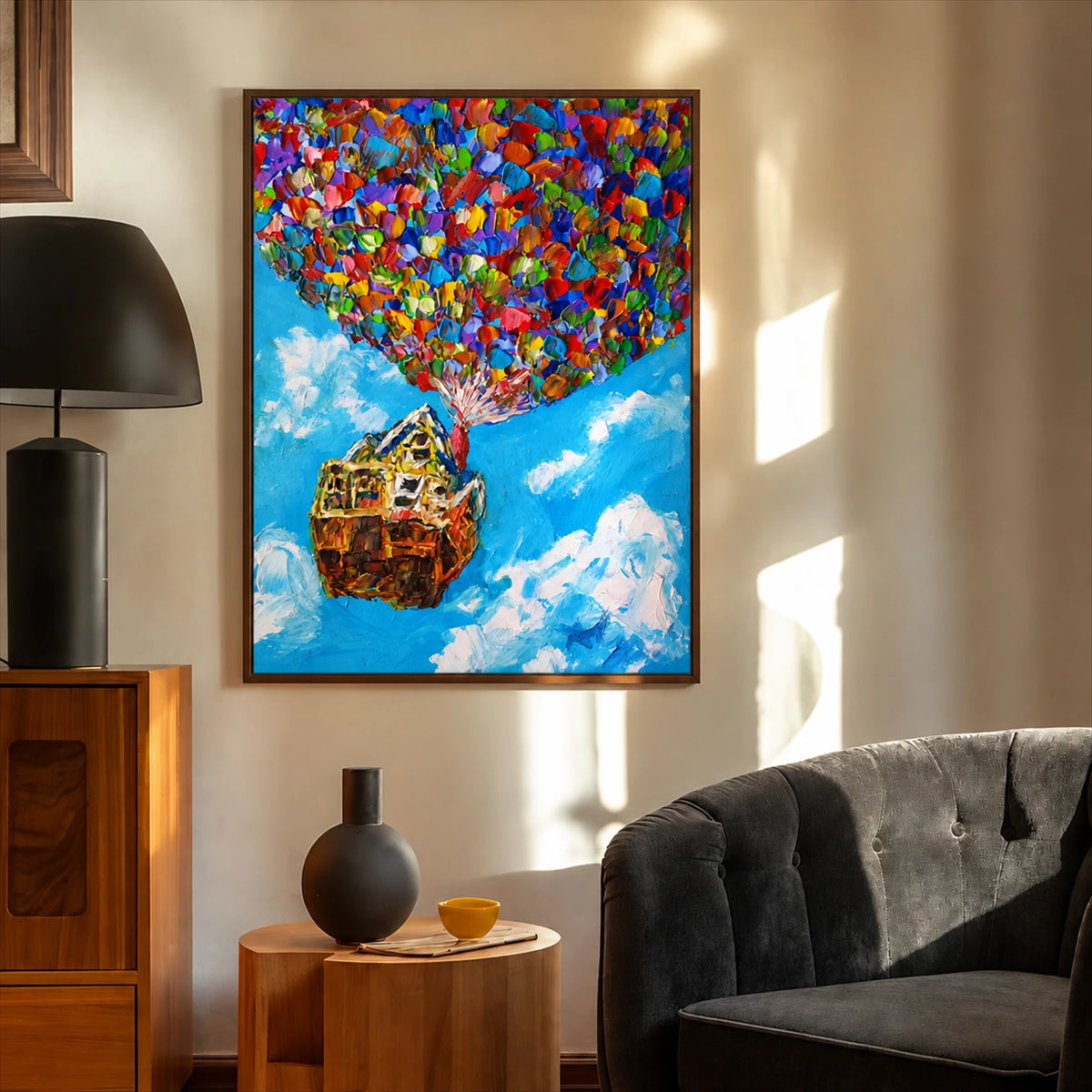 Balloon House painting in a dark frame beside a charcoal sofa and a small wood side table.