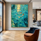 Sunlit Mermaids painting beside tall windows and a curved brown chair in a modern interior.