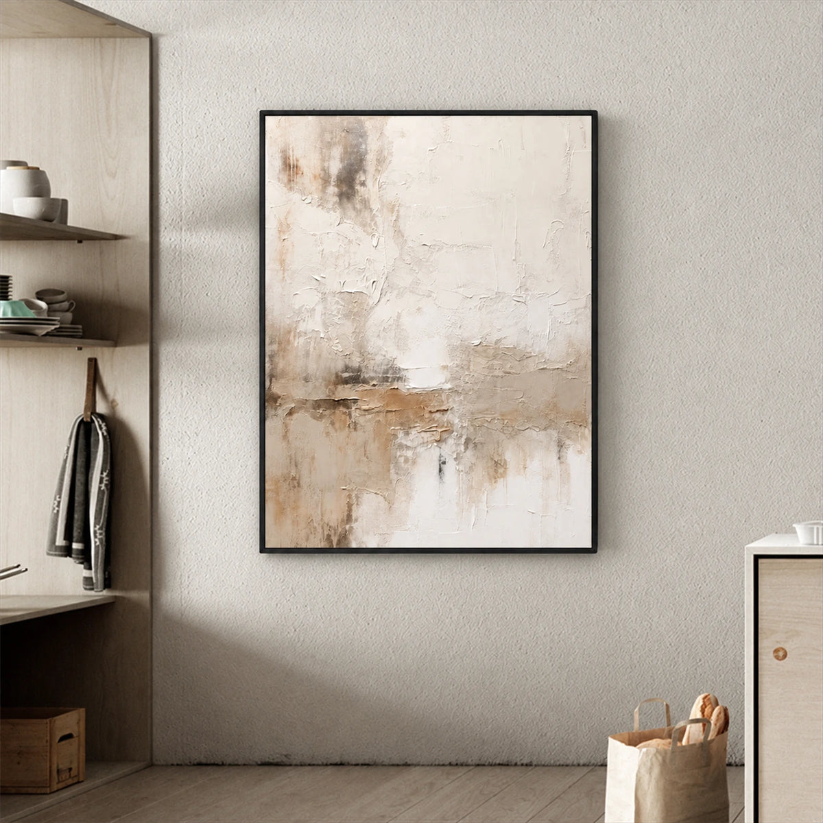 Quiet Earth painting in a dark frame beside open shelves and a woven basket in a neutral interior.