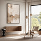 Quiet Earth painting above a floating wood cabinet beside a lounge chair and tall windows.