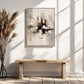 Urban Echo painting above a simple wood bench beside dried grasses and sunlit window shadows.