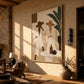 Palm Conversation painting on a warm textured wall beside a large vase and leather seating in afternoon light.