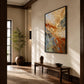 Gilded Currents painting above a long wood bench in a sunlit hallway.