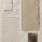 Full abstract artwork with pale rectangular forms, fine horizontal ridges and a small deep brown accent on an ivory field.