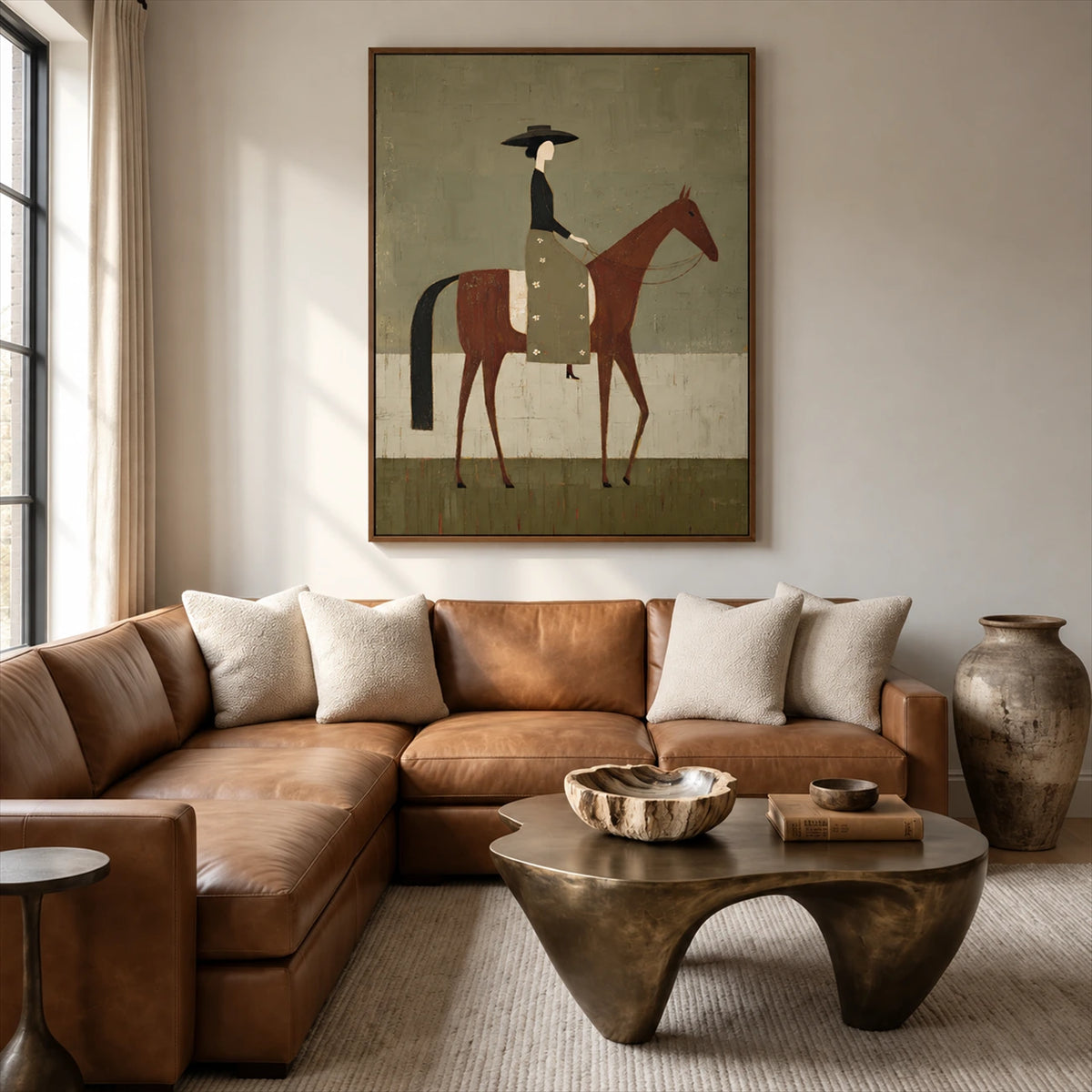 Olive Rider painting above a brown leather sectional sofa and sculptural wood coffee table.
