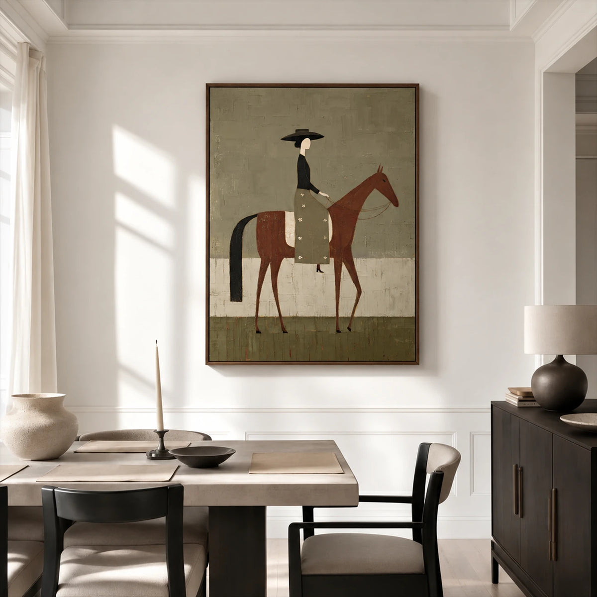 Olive Rider painting above a wood dining table beside a dark sideboard in a bright interior.