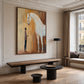 Gentle Bond painting above a long wood bench in a paneled room with tall windows.