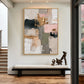Blush Mosaic painting above a long upholstered bench beside a staircase.