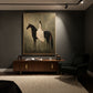 Silent Grace painting above a wood desk in a dark study lit by ceiling spotlights.