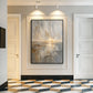 Gilded Horizon painting in a dark frame in a hallway with geometric floor tiles and white doors.