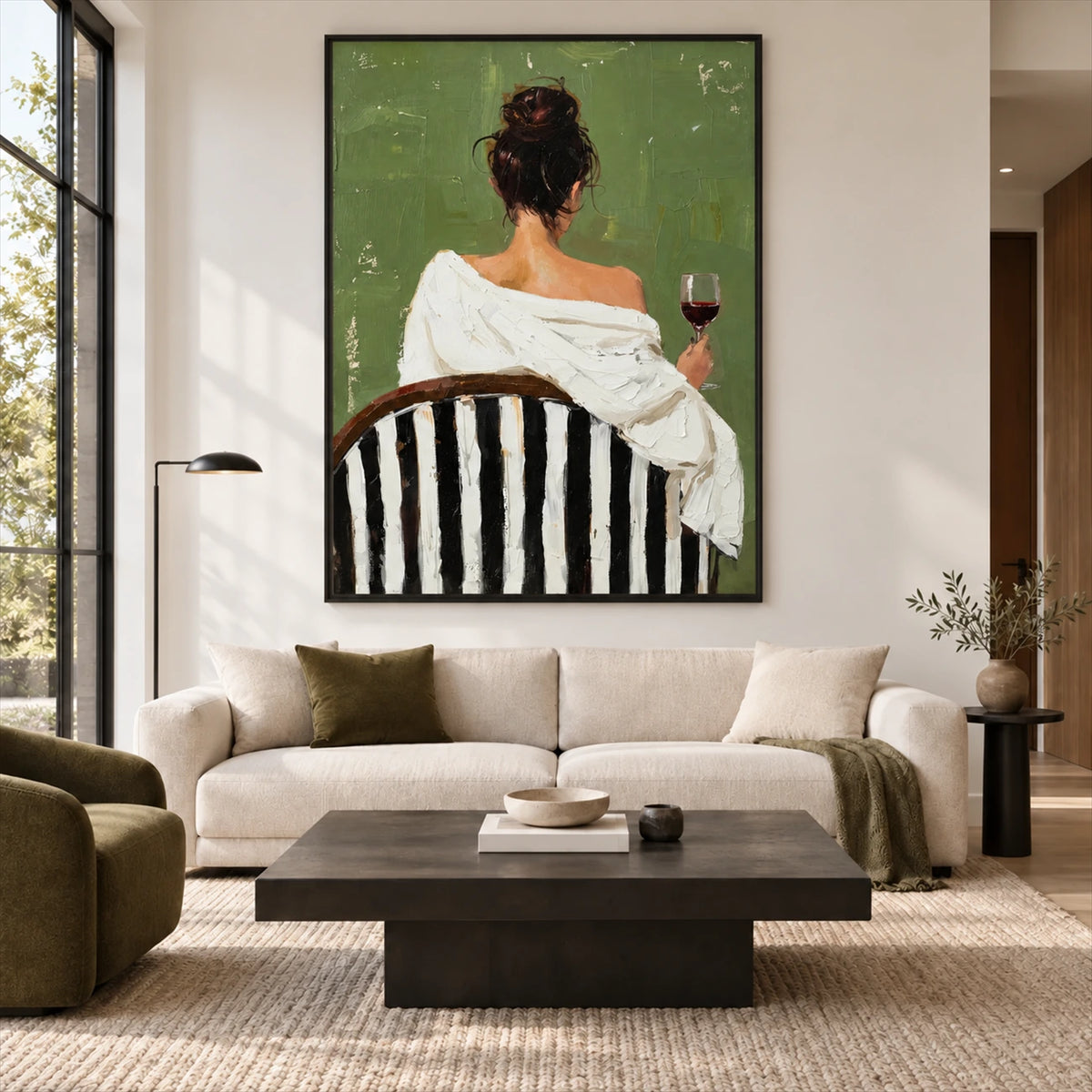 Evening Sip painting above a cream sofa and dark coffee table in a bright living room.