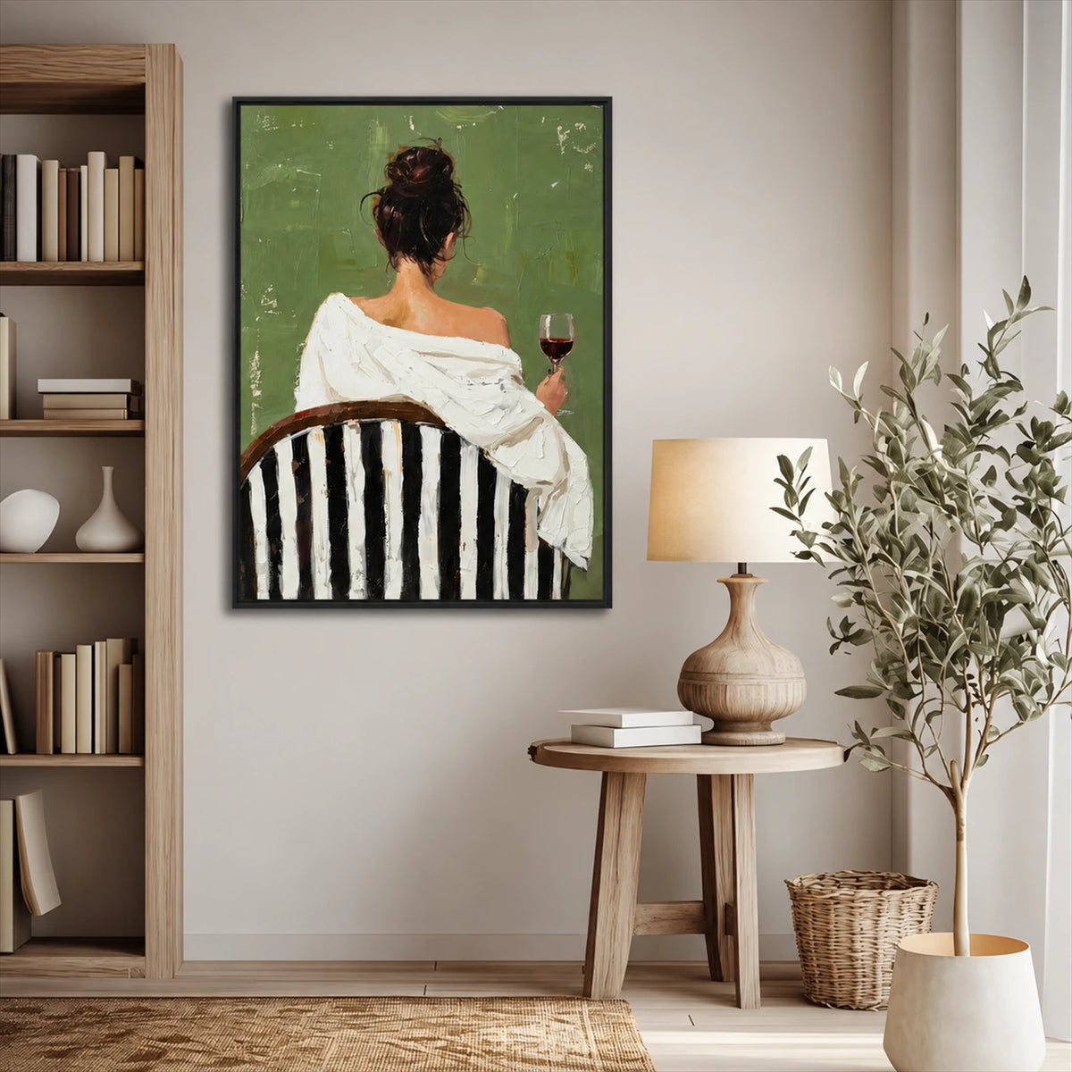 Evening Sip painting beside a bookshelf and round side table with a ceramic lamp.