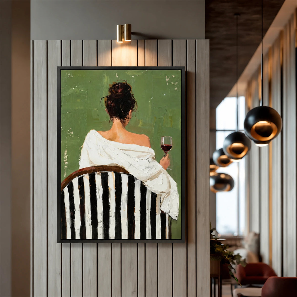 Evening Sip painting in a dark frame on a vertical slat wall beside hanging pendant lights.