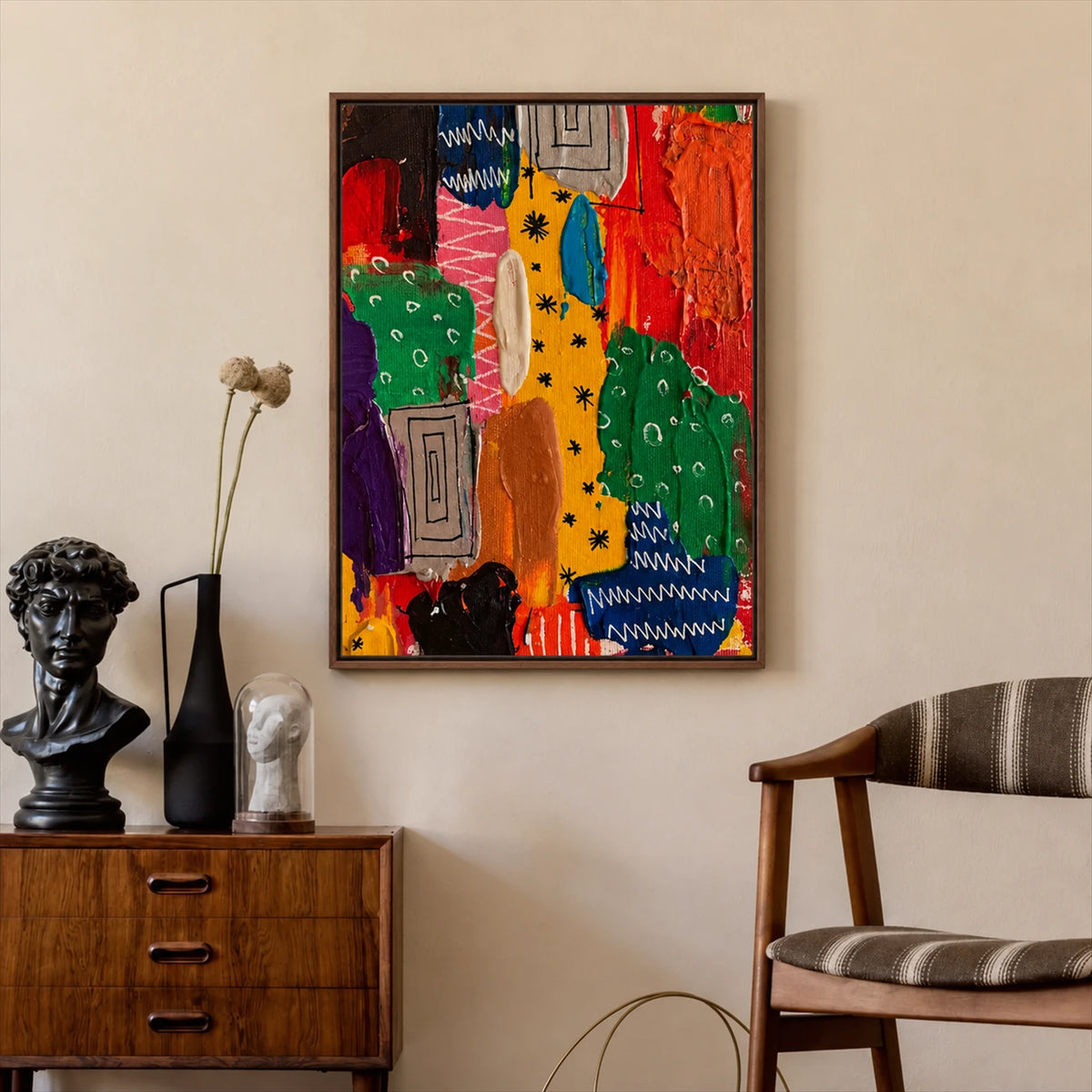 Color Rhythm painting above a wood cabinet with a sculptural bust beside an upholstered chair.