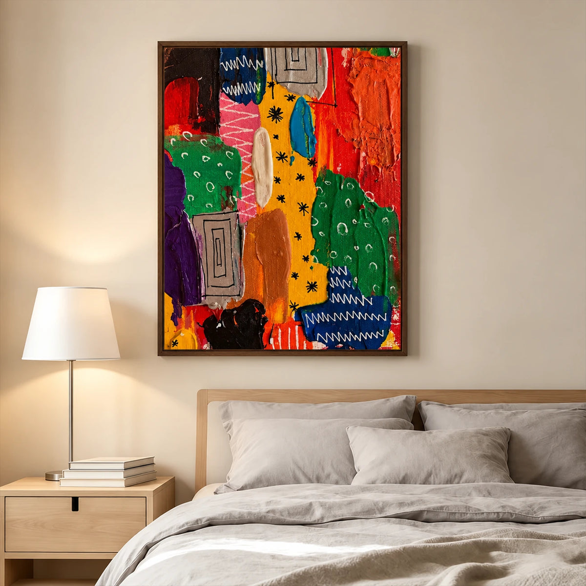 Color Rhythm painting above a bed with gray linens beside a light wood nightstand and lamp.