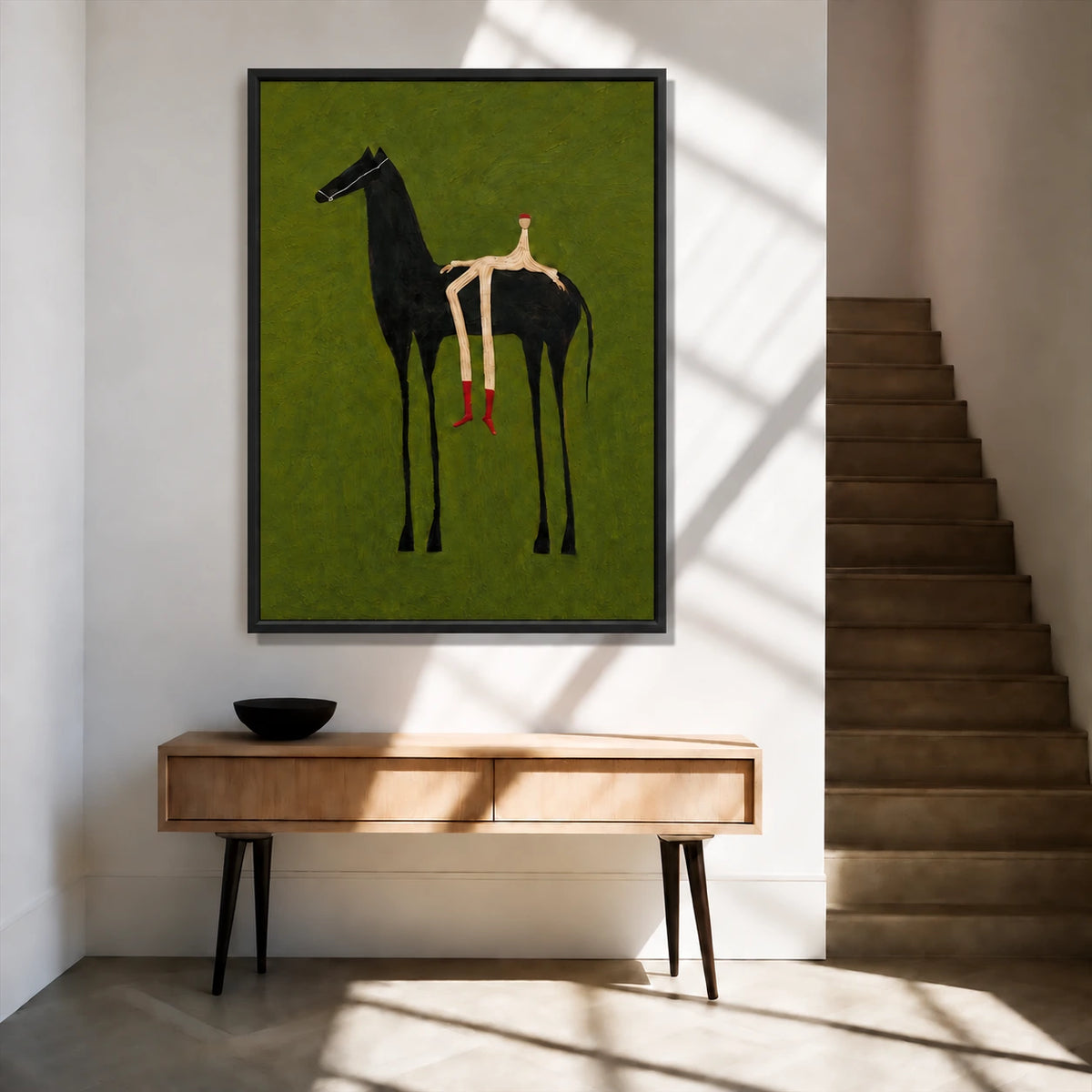 Emerald Rider painting above a wooden console beside a staircase in a sunlit entryway.
