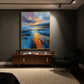 Amber Tide painting above a wood sideboard beside a dark armchair under gallery lighting.
