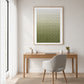 Olive Rhythm painting above a wooden desk and pale upholstered chair in a bright home office.