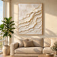 Ivory Tides painting above a beige sofa beside a leafy plant and sunlit window.