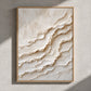 Ivory Tides painting in a natural wood frame on a gray wall crossed by sunlight.
