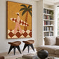 Ochre Surfer painting above two sculptural wooden stools beside bookshelves in a light living room.