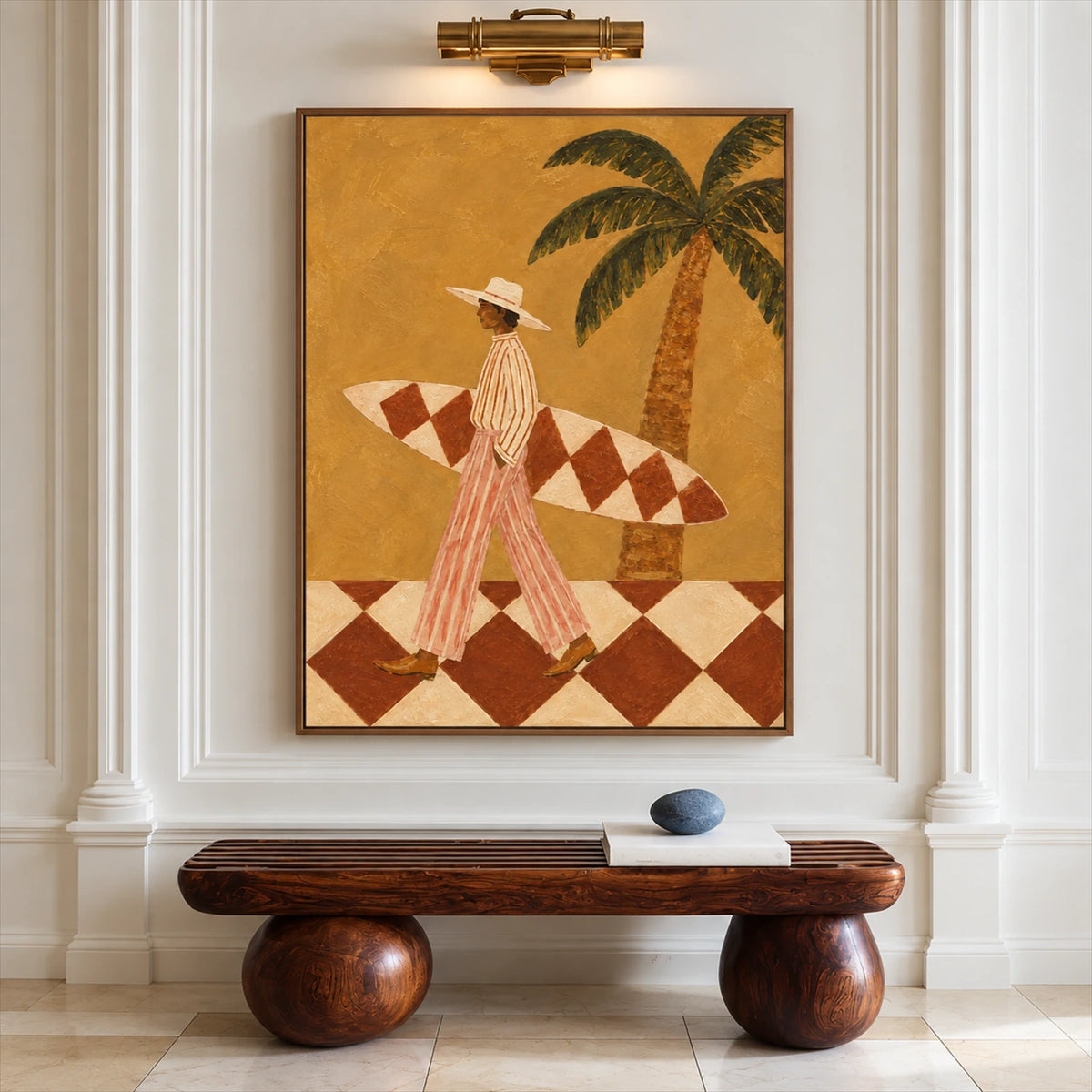 Ochre Surfer painting beneath a brass picture light above a sculptural wooden bench on a paneled wall.