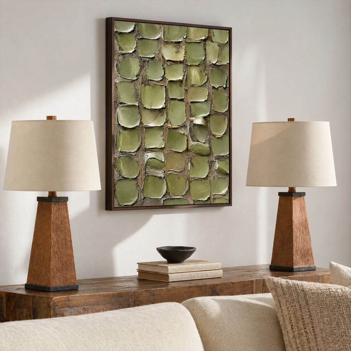 Olive Mosaic painting above a wooden console between two table lamps in a neutral living room.