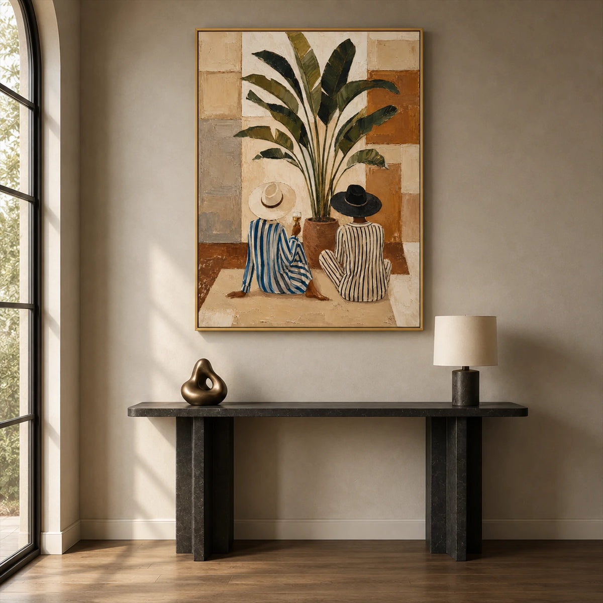 Leafside Companions painting above a slim dark console beside a tall arched window.