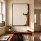 Quiet Perch painting above a wooden entry shelf with bags hanging beneath, beside a sunny window.