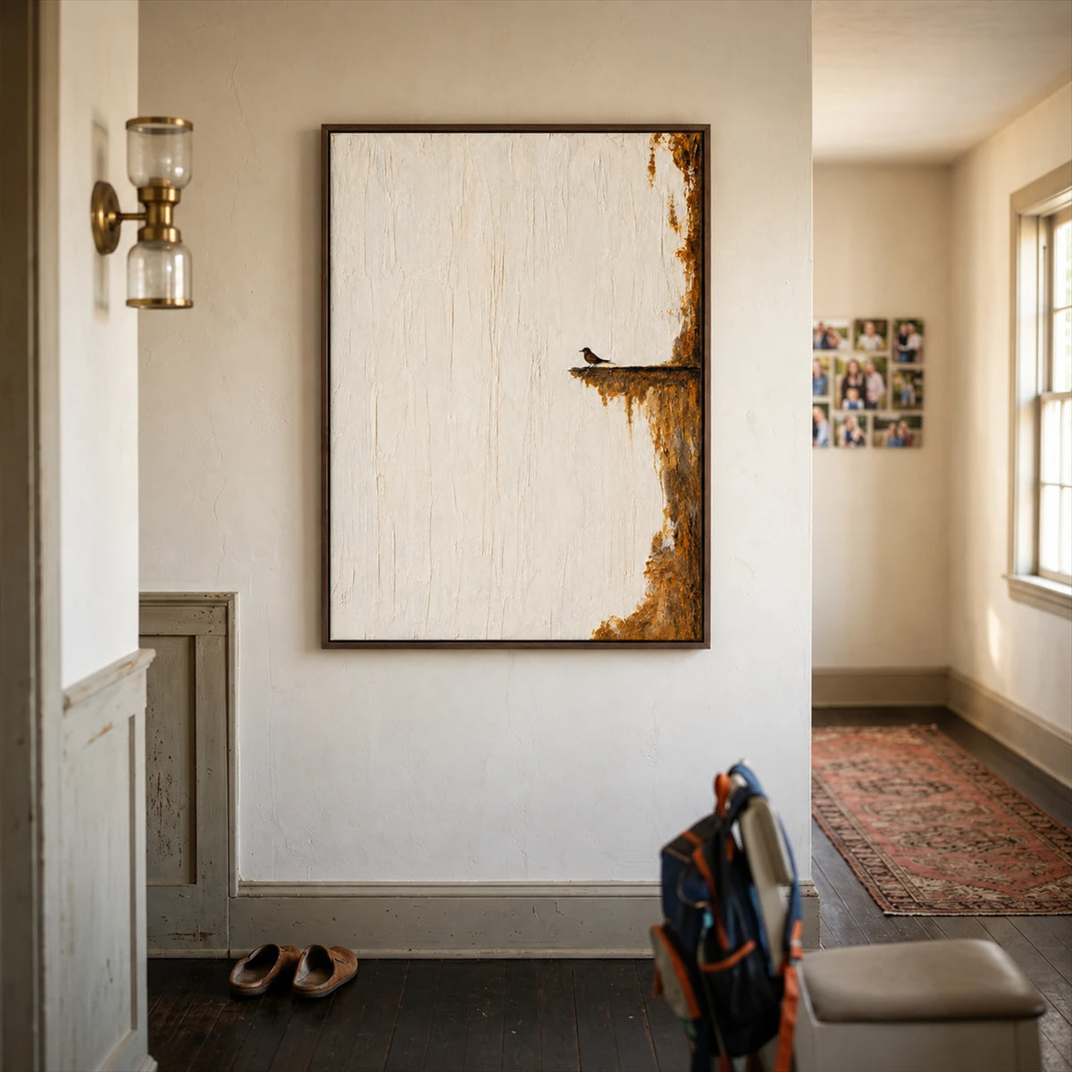 Quiet Perch painting on an entryway wall above shoes and a backpack near a hallway.