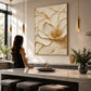 Gilded Blossom painting beside a dining counter and tall windows in a bright interior.