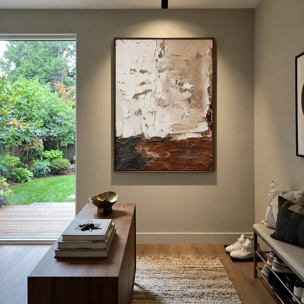 Earthen Layers painting beside an open garden doorway in a neutral room with a wooden console.