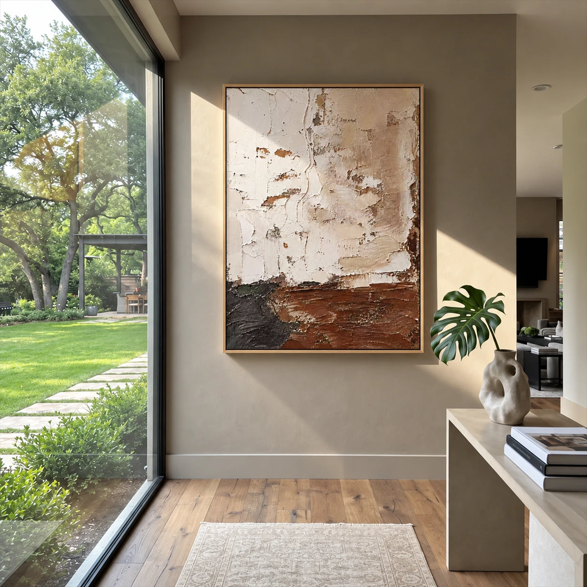 Earthen Layers painting beside a large garden-facing window and pale console in a bright entryway.