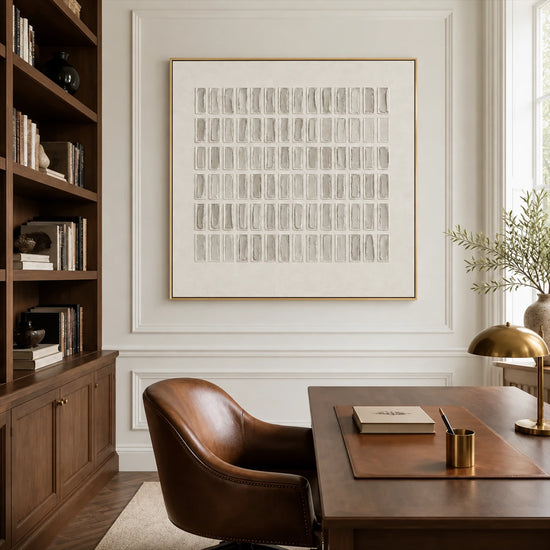 Quiet Grid painting behind a wooden desk and brown leather chair beside built-in bookshelves.