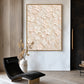 Ivory Petal Garden painting beside a black lounge chair and vase in a neutral room.