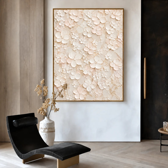 Ivory Petal Garden painting beside a black lounge chair and vase in a neutral room.